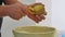 potato peeling close-up. a cook peels potatoes over a garbage can