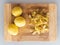 Potato peelings with potatoes on wooden cutting board on grey background. Top view