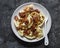 Potato pierogi with fried bacon and onions - delicious homemade lunch on a dark background, top view