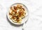 Potato pierogi with fried bacon and onions - delicious homemade lunch on a light background, top view