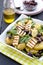 Potato salad with spinach, olives and grilled halloumi