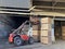 Potato storage facility. Forklift used to stack the crates. Refrigerated cold warehouse for potatoes and onions with wooden boxes.