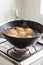 Potatoes boiling in a saucepan on a gas hob