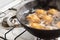 Potatoes boiling in a saucepan on a gas hob