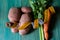 Potatoes, celery and carrots and a tailor& x27;s inch. Close-up on green wooden background. Christmas binge post diet concept