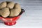 Potatoes in a drainer on a white wooden board with copy space