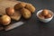 Potatoes, eggs, onions, cutting table. knife on dark background