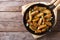 Potatoes fried in a pan, rustic style, horizontal top view