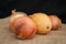 Potatoes with onion and pumpkin sprouts on a black background on sackcloth