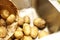 Potatoes and a paper bag in a kicthen sink