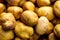 potatoes piled together on display with brown spots on them in a large pile