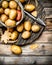 Potatoes in the sack on the tray with potato peeler