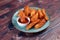 Potatos wedges with tomato sauce served in dish isolated on background side view of fastfood