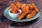 Potatos wedges with tomato sauce served in dish isolated on background side view of fastfood