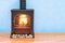 Potbelly stove, wood burner stove in room near wall, 3D