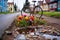 pothole filled with colorful flowers, with a bicycle passing by