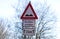 Pothole sign warning car driver at road damages german text translation `road damaged`
