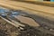 Potholes in roadway create hazardous driving.