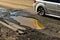 Potholes in roadway create hazardous driving for motorists.