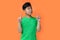 potrait asian boy with happy expression isolated at orange background.