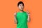 potrait asian boy with happy expression isolated at orange background