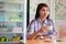 Potrait of a attractive asian women drinking cup a coffee at a cake store