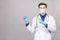 Potrait of handsome doctor wearing surgical protective mask and blue gloves