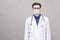 Potrait of handsome doctor wearing surgical protective mask and blue gloves