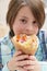 Potrait of hungry little boy biting gyros. Cute elementary age kid eating Greek fast food in a restaurant