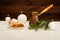 Pots of coffee, fir twig, apple pie, cinnamon sticks and candles on the wooden background