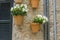 Pots hanging on the wall with flowers in the city of Valldemosa