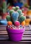 a potted cactus with colorful cacti