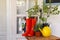 Potted plants, rubber boots and watering can on wooden table. Gardening tools