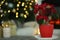 Potted poinsettia on stand in decorated room, space for text. Christmas traditional flower