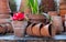 Potted red camelia flower amongst a creative display of terracotta pots.