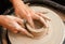 Potter, clay, hands making pottery circle close up