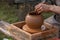 Potter is crafting clay pot in the summer