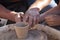 A potter craftsman transfers his skills to a student