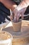 A potter craftsman transfers his skills to a student