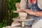 Potter forms a vase of clay on a potter`s wheel