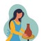 Potter girl. A woman sculpts a vase from clay behind a potter\\\'s wheel.