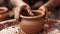 Potter hands making clay pot on wheel