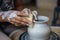 Potter making ceramic pot or vase on pottery wheel