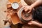 A potter paints a clay plate in a white in the workshop, top view, close-up, selective focus.