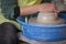 Potter`s hands making a clay pot on pottery