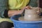 Potter`s hands making a clay pot on pottery