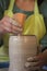 Potter`s hands making a clay pot on pottery