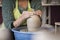 Potter`s hands making a clay pot on pottery