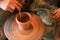 Potter's hands. Making clay products on a potter's wheel. Pottery master class.