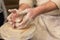 Potter`s hands at work close-up. Potter working clay on potter`s wheel